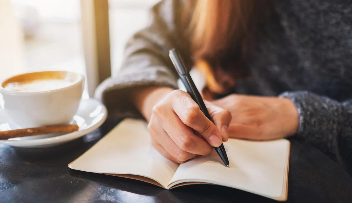 woman writing in a notebook