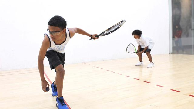 two teenagers playing racquetball
